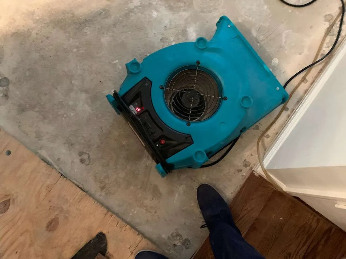 Air mover drying subfloor during Commercial Water Damage Restoration in Skippack